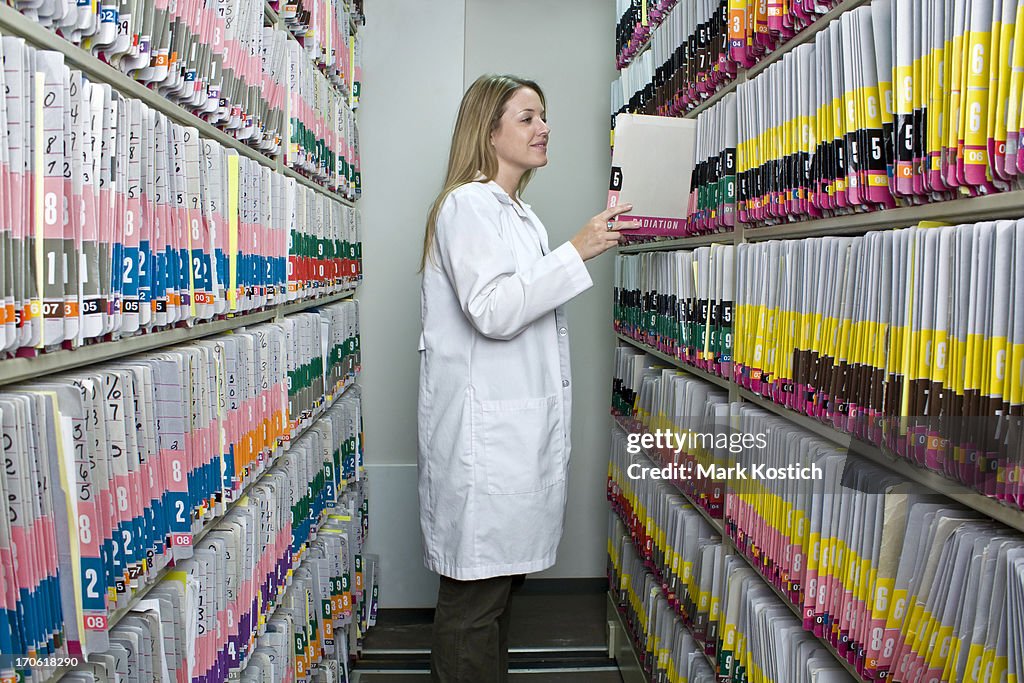 Woman Looking at Medical Records - Patient Charts