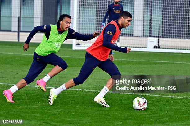 Achraf Hakimi and Ethan Mbappe fight for possession during a Paris Saint-Germain training session at Campus PSG on September 28, 2023 in Paris,...