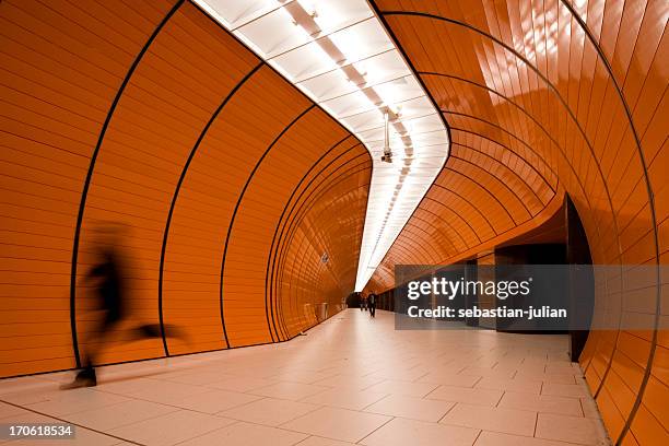 running commuter in modern organge subway tube - company town hall stock pictures, royalty-free photos & images