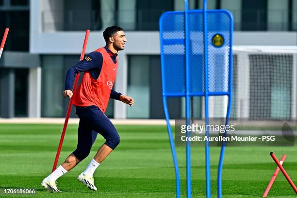 Achraf Hakimi warms up during a Paris Saint-Germain training session at Campus PSG on September 28, 2023 in Paris, France.
