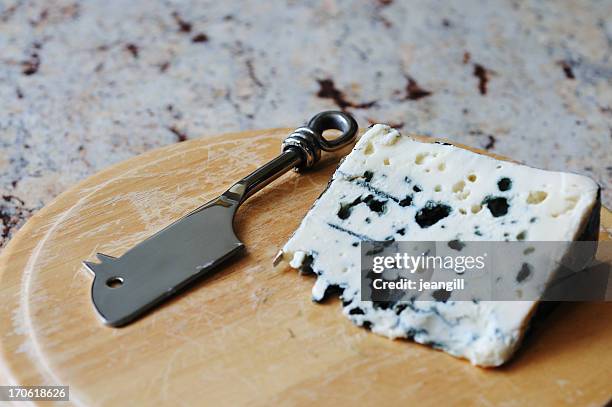 french roquefort blue cheese with mouse shaped knife - roquefort stockfoto's en -beelden