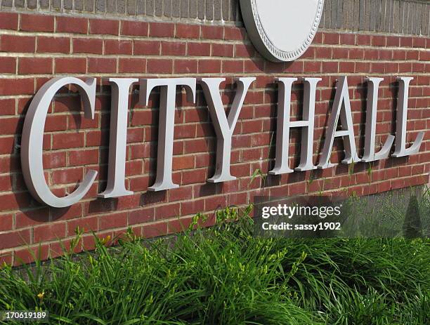 city hall sign brick wall close up - city council meeting stock pictures, royalty-free photos & images
