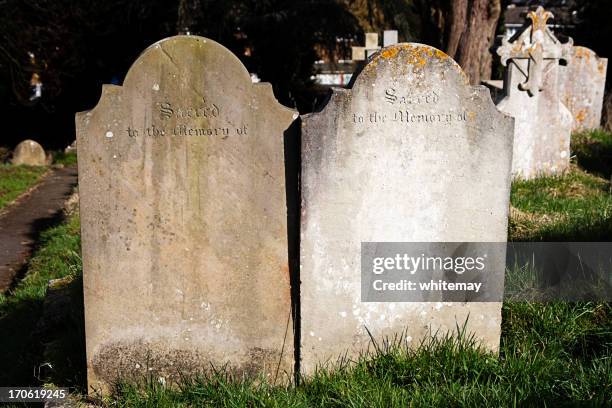 two gravestones - grafsteen stockfoto's en -beelden