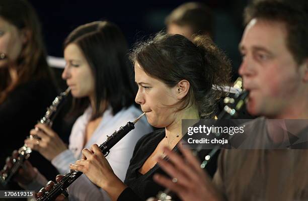 musicians at the concert...brass section playing - oboe stock pictures, royalty-free photos & images