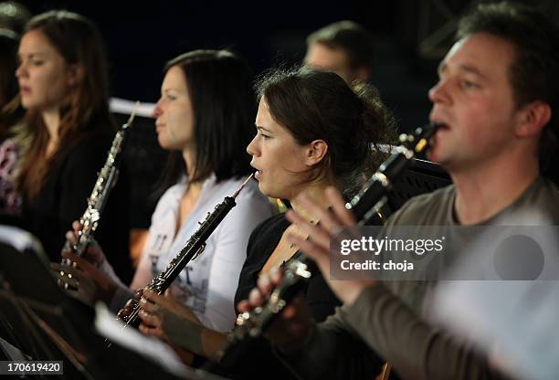 musicians at the concert...brass section playing - oboe stock pictures, royalty-free photos & images