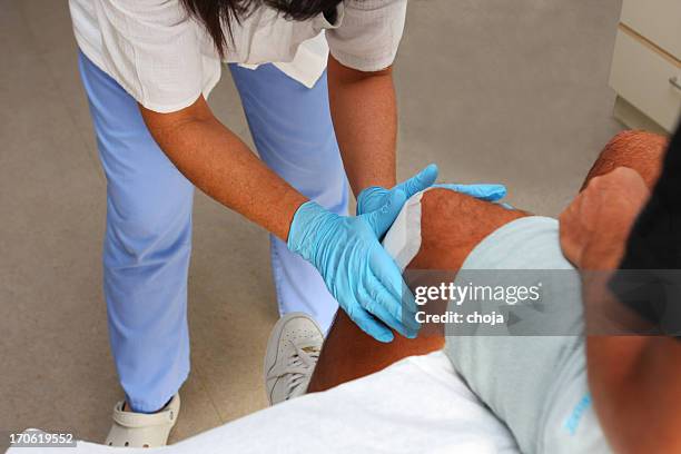 nurse is taking care of the wounded knee,changing bandage - nurse wound stock pictures, royalty-free photos & images