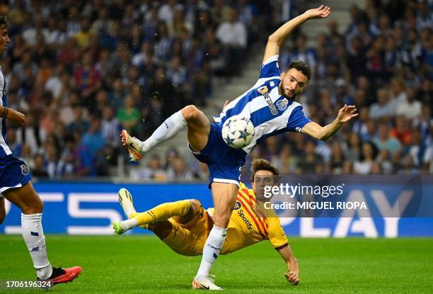 Porto's Portuguese defender Joao Mario vies with Barcelona's Portuguese forward Joao Felix during the UEFA Champions League 1st round day 2 group H...