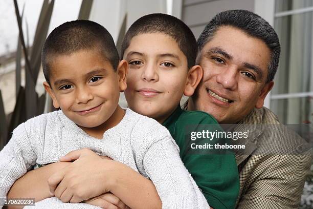 hispanic father and sons in front of house - crew cut stock pictures, royalty-free photos & images