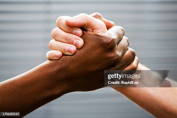 black-white arm wrestling - hands together stock pictures, royalty-free photos & images