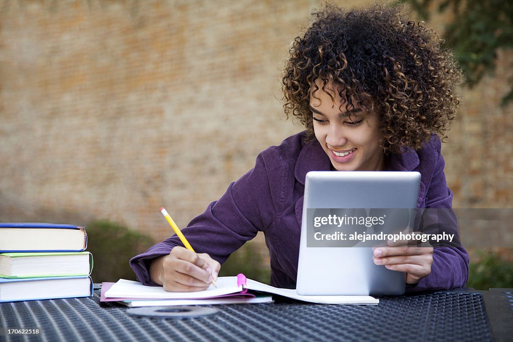 A happy young girl using a tablet