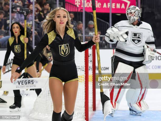 Members of the Knights Guard clean the ice as Jean-Francois Berube of the Los Angeles Kings waits in the crease during a preseason game between the...