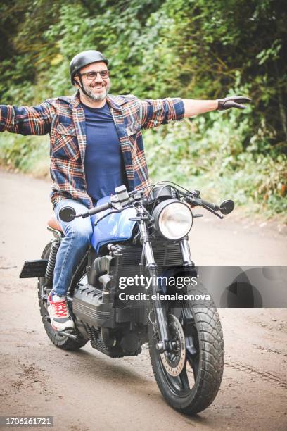 man seat on the motorcycle - single cylinder motorcycle stock pictures, royalty-free photos & images