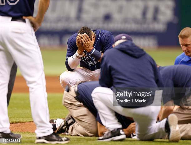 Shortstop Yunel Escobar of the Tampa Bay Rays reacts after pitcher Alex Cobb is hit by a line drive against the Kansas City Royals during the game at...