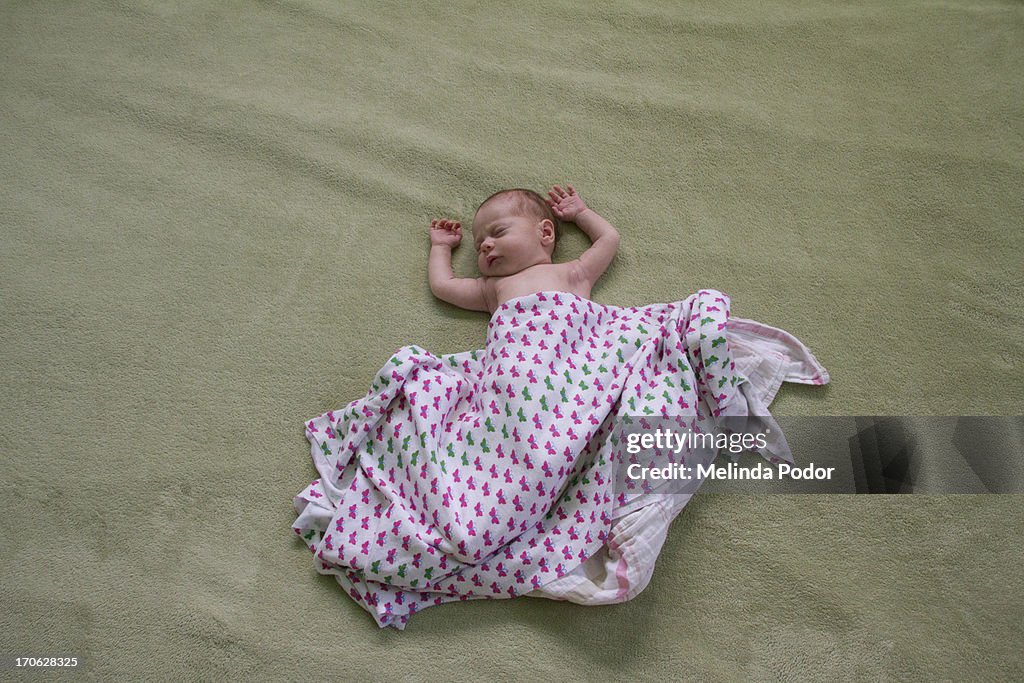 Newborn baby on bed