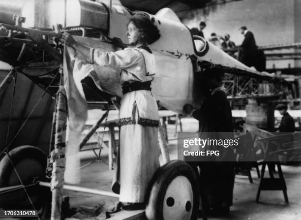 British aviator Hilda Hewlett assembling a Caudron biplane at Hewlett's Omnia Works, in Clapham Junction, London, England, circa 1915. Hewlett was...