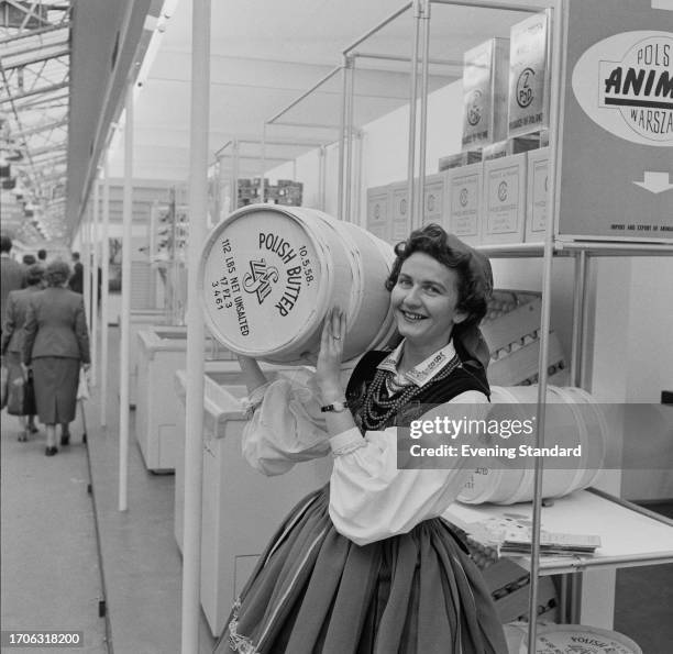 Woman carries a keg of butter at the Polish dairy stand, British Food Fair, Olympia, London, September 4th 1958.