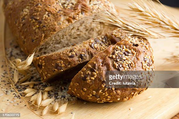 black bread with seeds of sesame, poppy and flax - fibre stock pictures, royalty-free photos & images