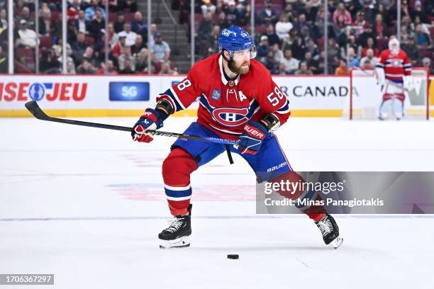 David Savard of the Montreal Canadiens skates the puck during the second period against the Ottawa Senators at the Bell Centre on September 27, 2023...