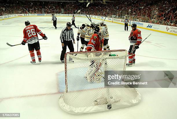 Chris Kelly of the Boston Bruins celebrates with teammates after scoring a goal in the second period to tie the game up against Corey Crawford of the...