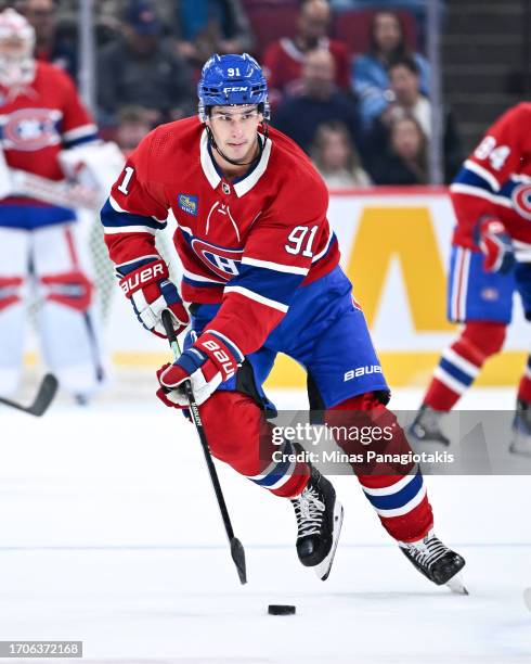 Sean Monahan of the Montreal Canadiens skates the puck during the second period against the Ottawa Senators at the Bell Centre on September 27, 2023...