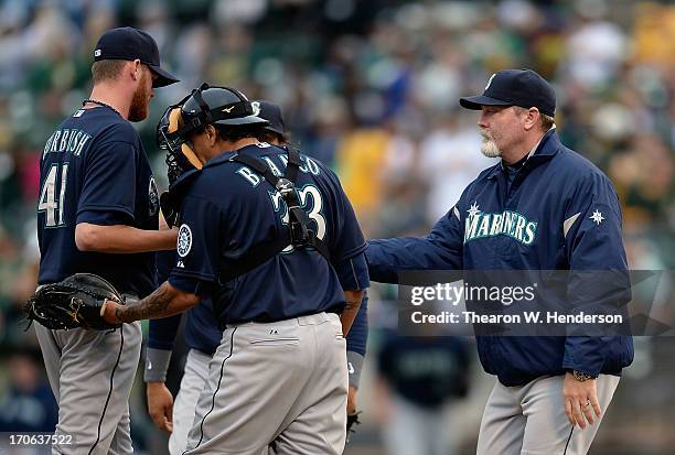 Manager Eric Wedge takes the ball from pitcher Charlie Furbush taking him out of the game in the ninth inning against the Oakland Athletics at O.co...