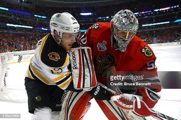 Tyler Seguin of the Boston Bruins and goalie Corey Crawford of the Chicago Blackhawks get their sticks tied up in Game Two of the NHL 2013 Stanley...