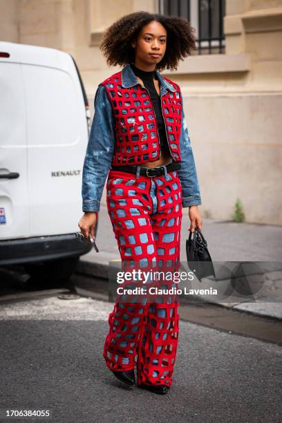 Guest wears, a denim jacket with red checked details and matching jeans, black bag and black heels outside Marni, during the Womenswear Spring/Summer...