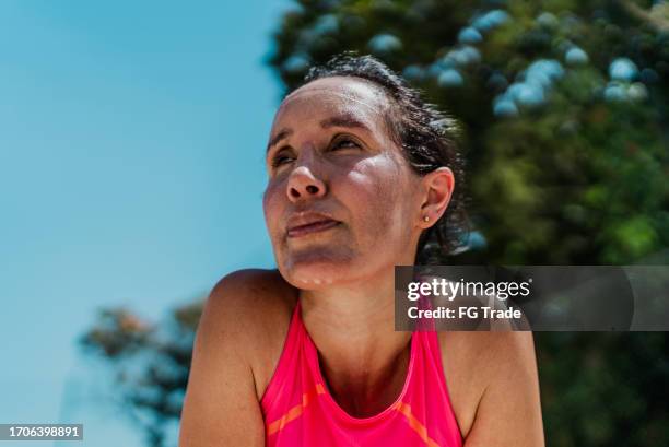 tired mature woman sweating during sports activity - suor imagens e fotografias de stock