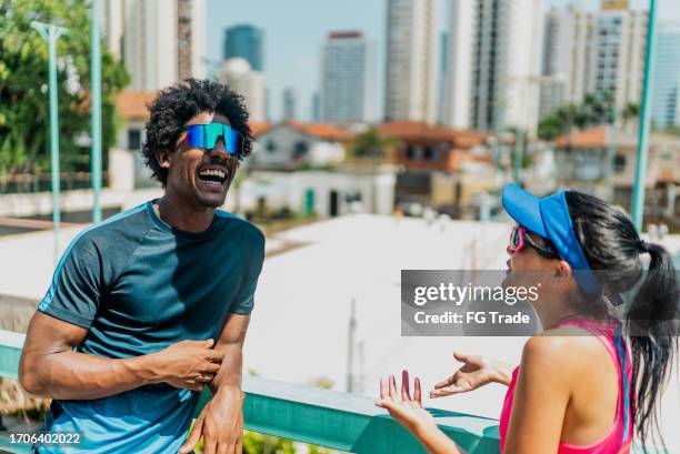 friend talking at beach tennis court - beach football stock pictures, royalty-free photos & images