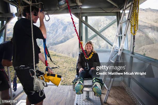 preparing for a bungee jump in queenstown - woman bungee jumping stock pictures, royalty-free photos & images