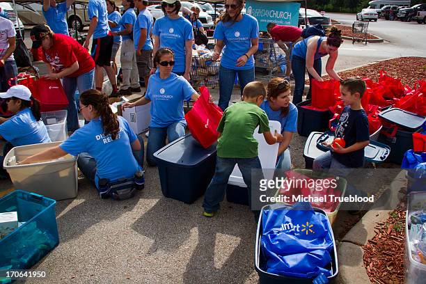 Members of the Everyday Church help with the recovery in Moore, Oklahoma. The workers put together packages of food, water, and supplies for the...