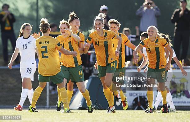 Clare Polkinghorne of Australia celebrates with team mates after scoring a goal during the Women's International match between the Australian...