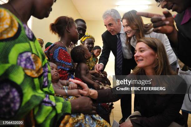 French First Lady Carla Bruni-Sarkozy , Melinda Gates spouse of US IT mogul Bill Gates and AIDS World Fund Director Michel Kazatchkine speak with...