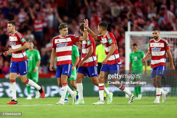 Lucas Boye of Granada celebrates with teammate Raul Torrente after scoring the team's first goal during the LaLiga EA Sports match between Granada CF...