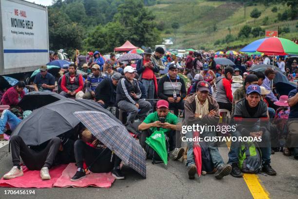 Indigenous people block a road during a protest demanding the resignation of Attorney General Consuelo Porras and prosecutor Rafael Curruchiche in...