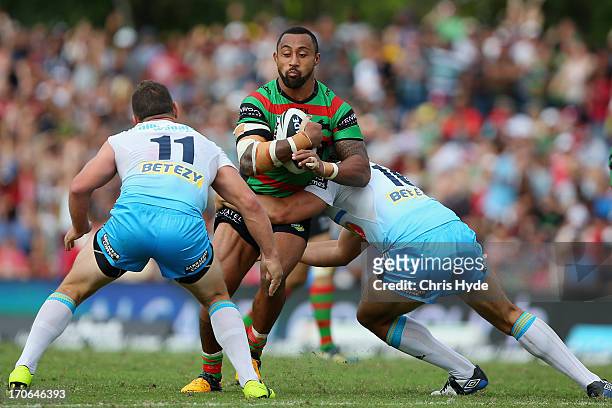 Roy Asotasi of the Rabbitohs is tackled during the round 14 NRL match between the South Sydney Rabbitohs and the Gold Coast Titans at Barlow Park on...