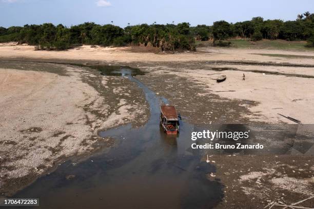 Aerial view of boat stranded in a drought-hit harbor of Cacau Pirêra on October 04, 2023 in Iranduba, Amazonas, Brazil. The state of Amazonas remains...