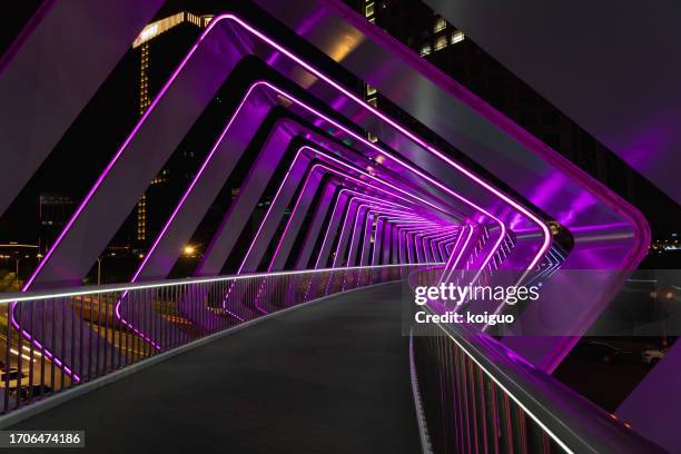 pedestrian bridge with purple light effects - footbridge stock pictures, royalty-free photos & images