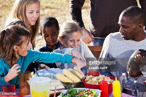 neighbors having picnic - family eating potato chips stock pictures, royalty-free photos & images