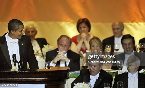 Republican presidential candidate John McCain laughs as US Democratic presidential candidate Barack Obama speaks at the Alfred E. Smith Memorial...