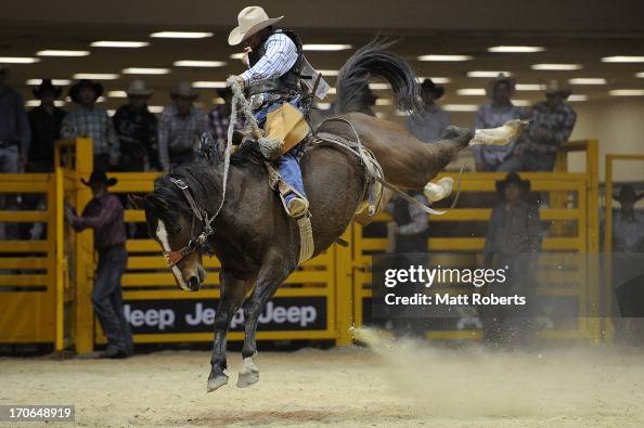 Jason Crawford of Dingo competes in the Saddle Bronc Riding during ...
