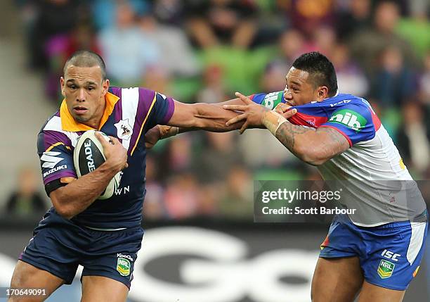 Will Chambers of the Storm is tackled by Joey Leilua of the Knights during the round 14 NRL match between the Melbourne Storm and the Newcastle...