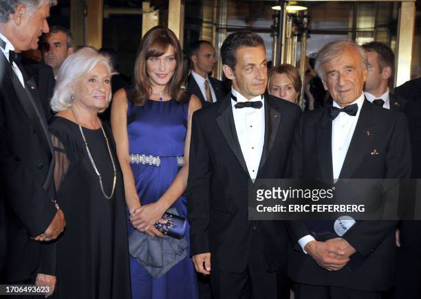 French President Nicolas Sarkozy , his wife Carla Bruni-Sarkozy attend a ceremony before receiving the Humanitarian Award from Nobel Prize recipient...