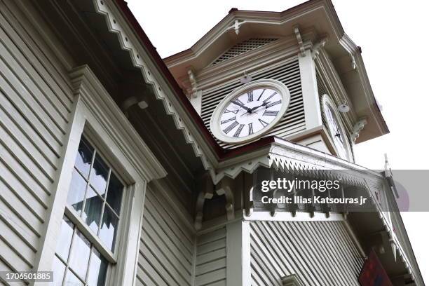 clock tower on old classic wood building in sapporo high key - turmuhr stock-fotos und bilder