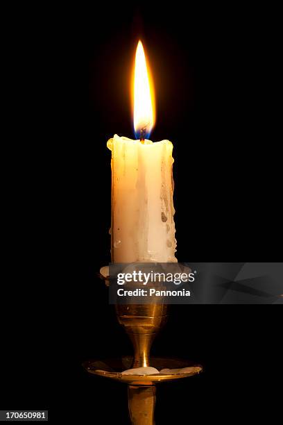 candle on copper holder - burning candle stock pictures, royalty-free photos & images