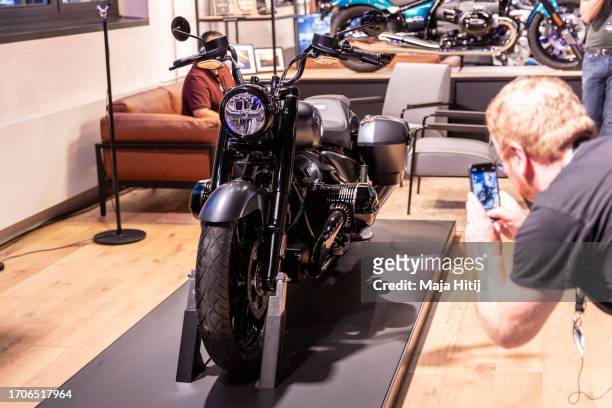 Visitor takes a photo of "BMW R18 Roctane" Motorcycle at event to celebrate the 100th anniversary of BMW motorcycles at the Spandau BMW motorcycle...