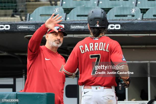 Manager Torey Lovullo of the Arizona Diamondbacks celebrates a run with Corbin Carroll during the third inning in the game against the Chicago White...