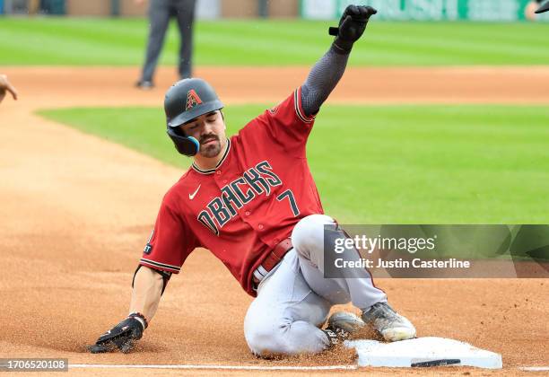 Corbin Carroll of the Arizona Diamondbacks slides into third base during the third inning in the game against the Chicago White Sox at Guaranteed...