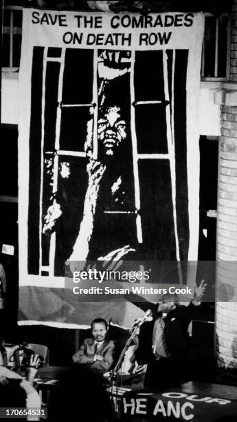 Under a large poster that reads 'Save the Comrades on Death Row,' Bishop Desmond Tutu addresses an audience at Western Cape University in Cape Town,...