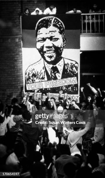 Under a large poster that reads 'Your Freedom is Our Freedom,' demonstrators protest the continued incarceration of ANC leaders, at Western Cape...